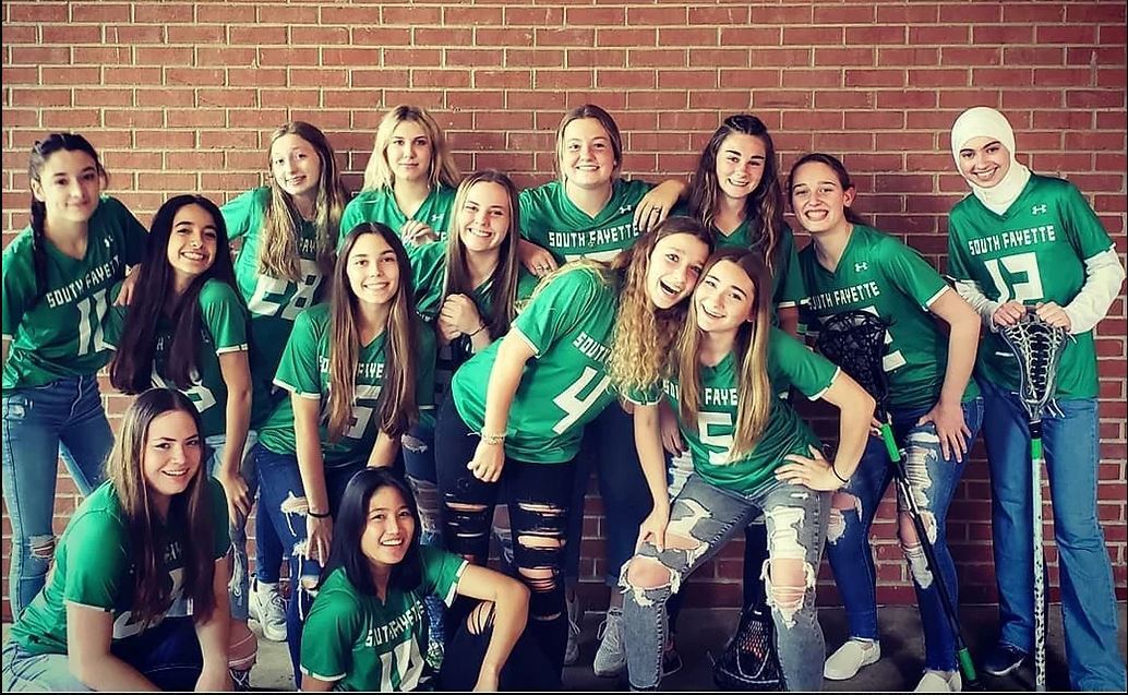 group of girls with lacrosse equipment