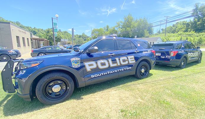 dark blue police cars parked at police station